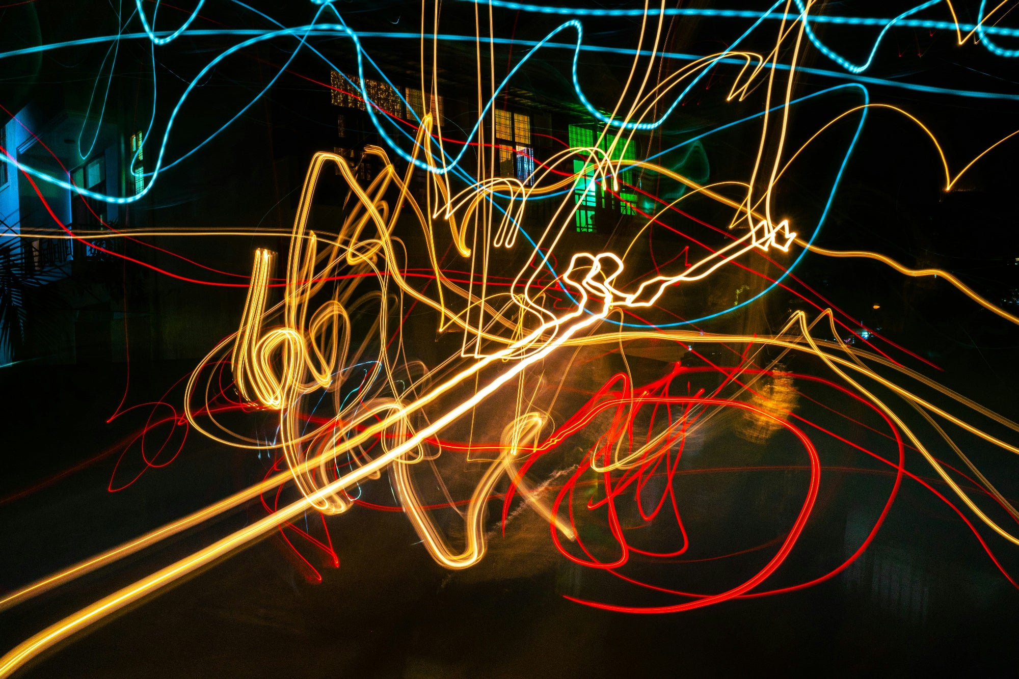 Long exposure of colorful light streaks on a dark background
